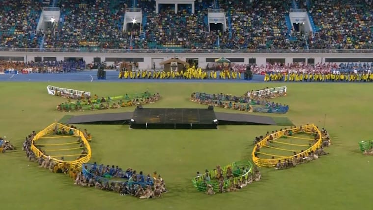 Wide of infield during Opening Ceremony featuring performers holding canoe frames.