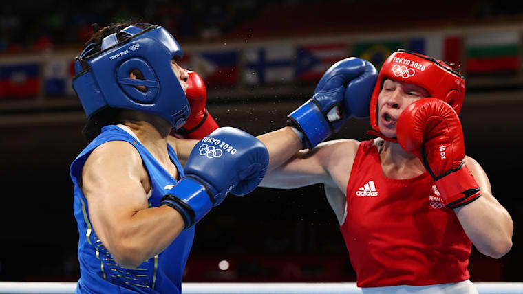 Lauren Price (Great Britain) and Qian Li (People's Republic of China) clash during the women's 75kg final at the Tokyo 2020 Olympic Games
