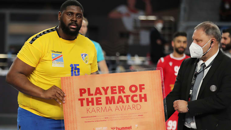 Gauthier Mvumbi receives his Player of the Match award after DR Congo's defeat to Bahrain at the 2021 World Championship