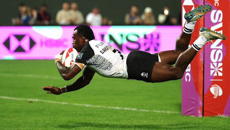 Fiji's Filipe Sauturaga scores a try during a pool match between Fiji and New Zealand on day one of the HSBC SVNS in Dubai.
