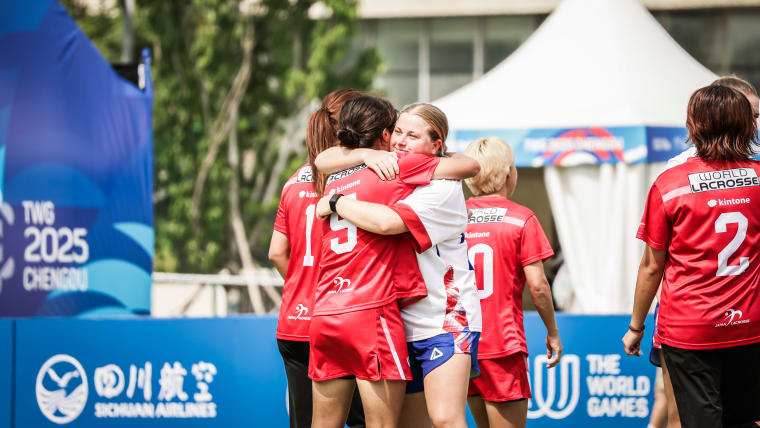 Lacrosse athletes embrace after a match between Japan and Great Britain at The World Games 2025