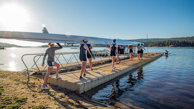 U.S. Rowing's women's eight sweep being carried to the water at Big Bear Lake