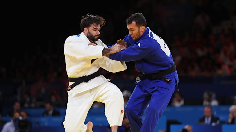 Rafael Macedo (white) of Team Brazil and Christian Parlati (blue) of Team Italy compete in the Men -90kg of the Judo Mixed Team Bronze Medal match on day eight of the Olympic Games Paris 2024 at Champs-de-Mars Arena on August 03, 2024 in Paris, France.