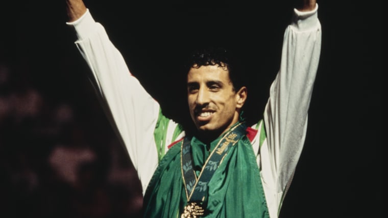Hocine Soltani from Algeria stands on the podium after winning the gold medal by defeating Tontcho Tontchev of Bulgaria on 3 August 1996 at the Alexander Memorial Coliseum in Atlanta, Georgia, United States. 