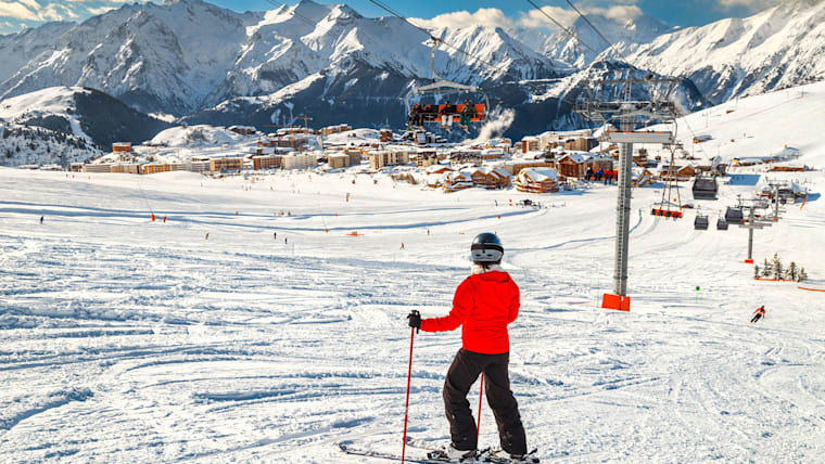 Skiers on the slopes at Alpe d’Huez ski resort in the French Alps