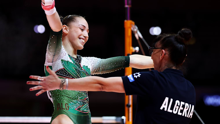 Kaylia Nemour of Team Algeria embraces her coach after competing in the women's uneven bars apparatus final at 2025 World Championships 