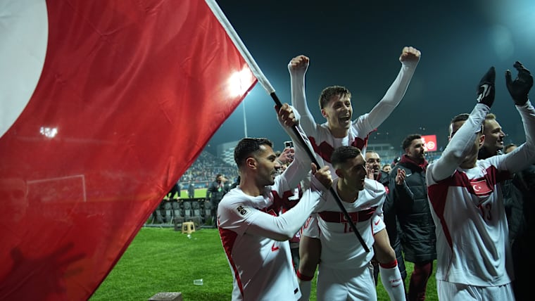 Zeki Celik, Arda Gueler and Mert Muelduer of Turkiye celebrate victory and qualification for the FIFA World Cup 2026 after the FIFA World Cup 2026 European Qualifiers KO play-offs match between Kosovo and Türkiye at Fadil Vokkri Stadium on March 31, 2026 in Pristina, Kosovo. [Ferdi Limani/Getty Images]