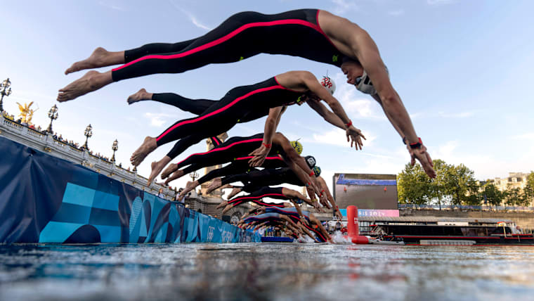 Competitors dive into the Seine river for the start of the marathon swimming men's 10km at the 2024 Paris Olympics.