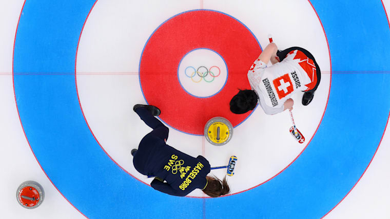Esther Neuenschwander (SUI) and Anna Hasselborg (SWE) compete in curling at the Beijing 2022 Winter Olympic Games