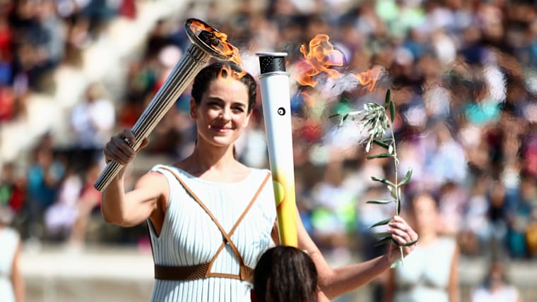 Gangwon 2024 Winter YOG, Olympic flame lighting Ceremony, Athens, 2023 - Actress Xanthi GEORGIOU, in the role of the high priestess, and Maria BELLI (GRE), Cross-country skiing and Biathlon, and first torch bearer.