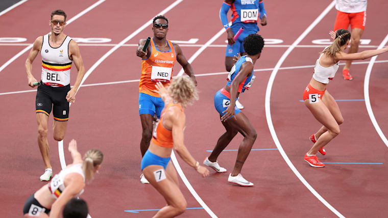 Runners pass their batons in the 4x400m mixed relay final at the Tokyo 2020 Olympic Games