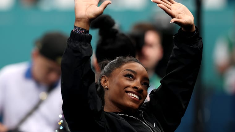 Simone Biles of Team United States waves to the crowd