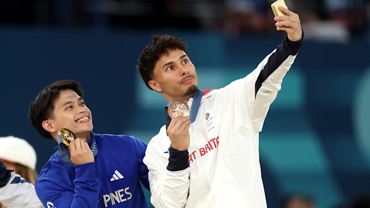 Gold medalist Carlos Edriel Yulo of Team Philippines and Bronze medalist Jake Jarman of Team Great Britain pose for a selfie