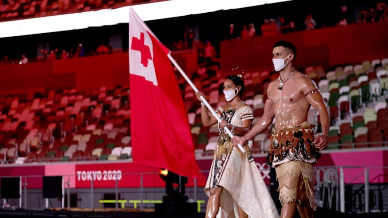 Tonga flag bearers Malia Paseka (L) and Pita Taufatofua (R) during the Opening Ceremony of the Tokyo 2020 Olympic Games 