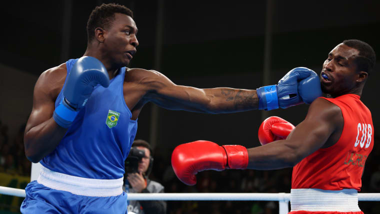 Cuba's double Olympic champion Julio Cesar La Cruz (R) in action