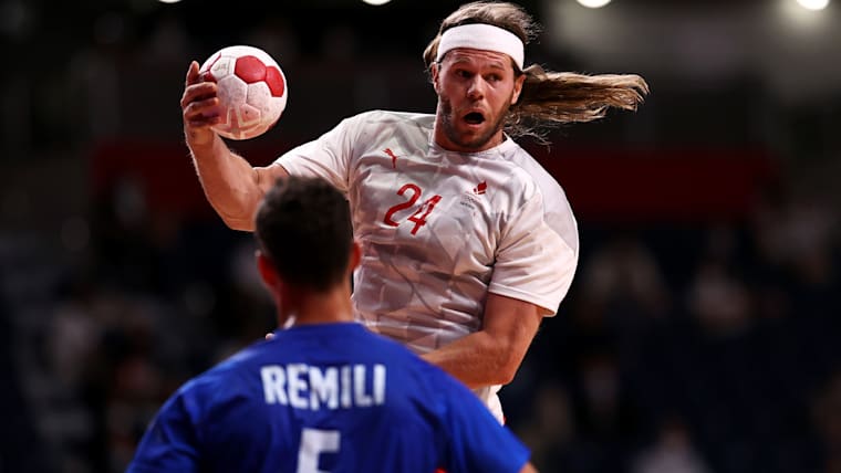 Mikkel Hansen of Team Denmark passes the ball as Nedim Remili of Team France looks on during the Men's Gold Medal handball match between France and Denmark on day fifteen of the Tokyo 2020 Olympic Games at Yoyogi National Stadium on August 07, 2021 in Tokyo, Japan.