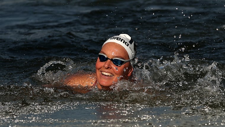 Sharon van Rouwendaal of Team Netherlands celebrates as she crosses the finish to win gold in the Marathon Swimming Women's 10k on day thirteen of the Olympic Games Paris 2024 at Pont Alexandre III on August 08, 2024 in Paris, France.