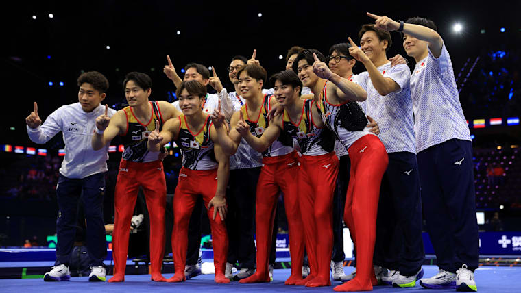 Team Japan pose for a photo after winning the Men's Team Final