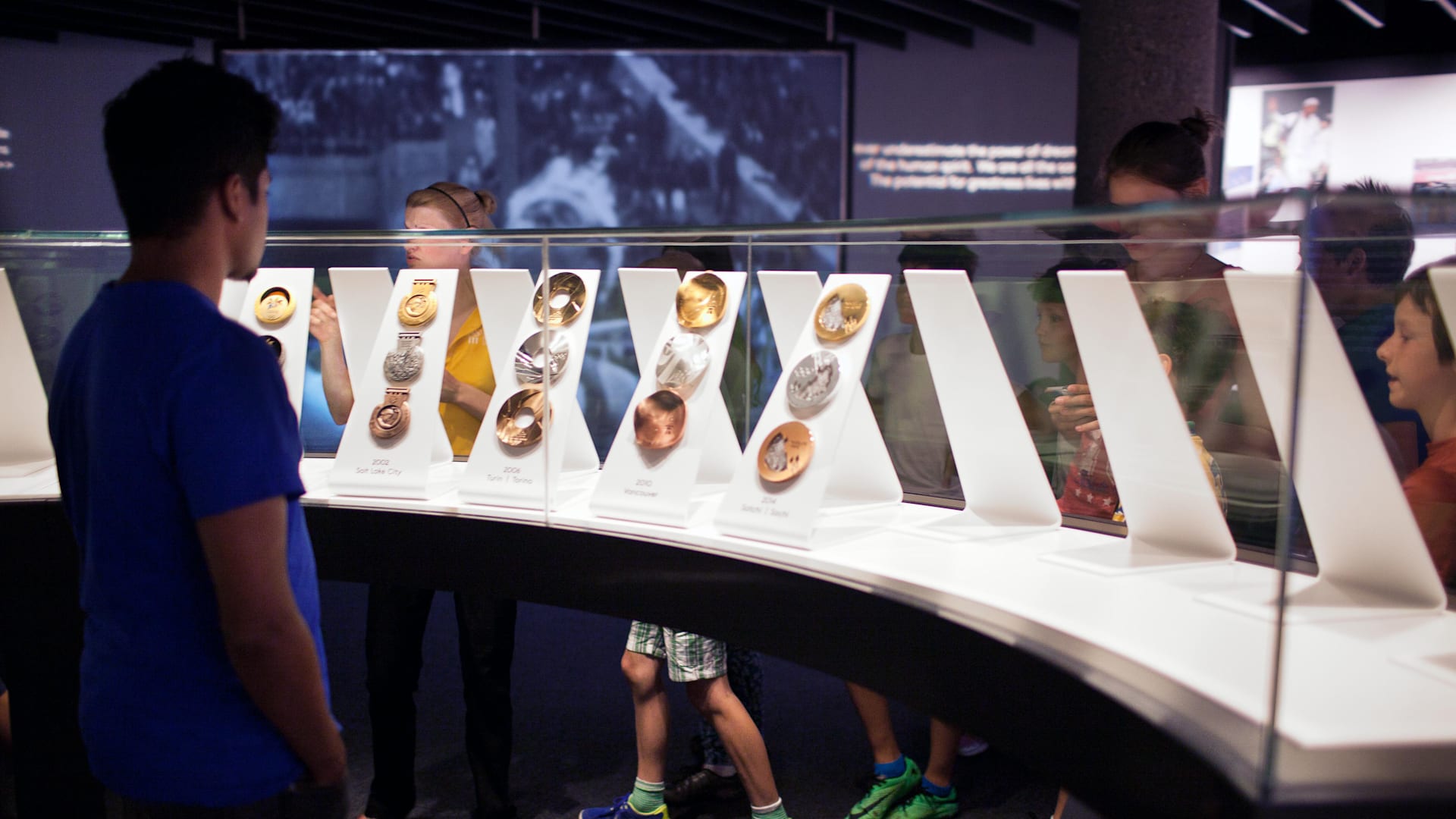 Kid observing the Olympics medals