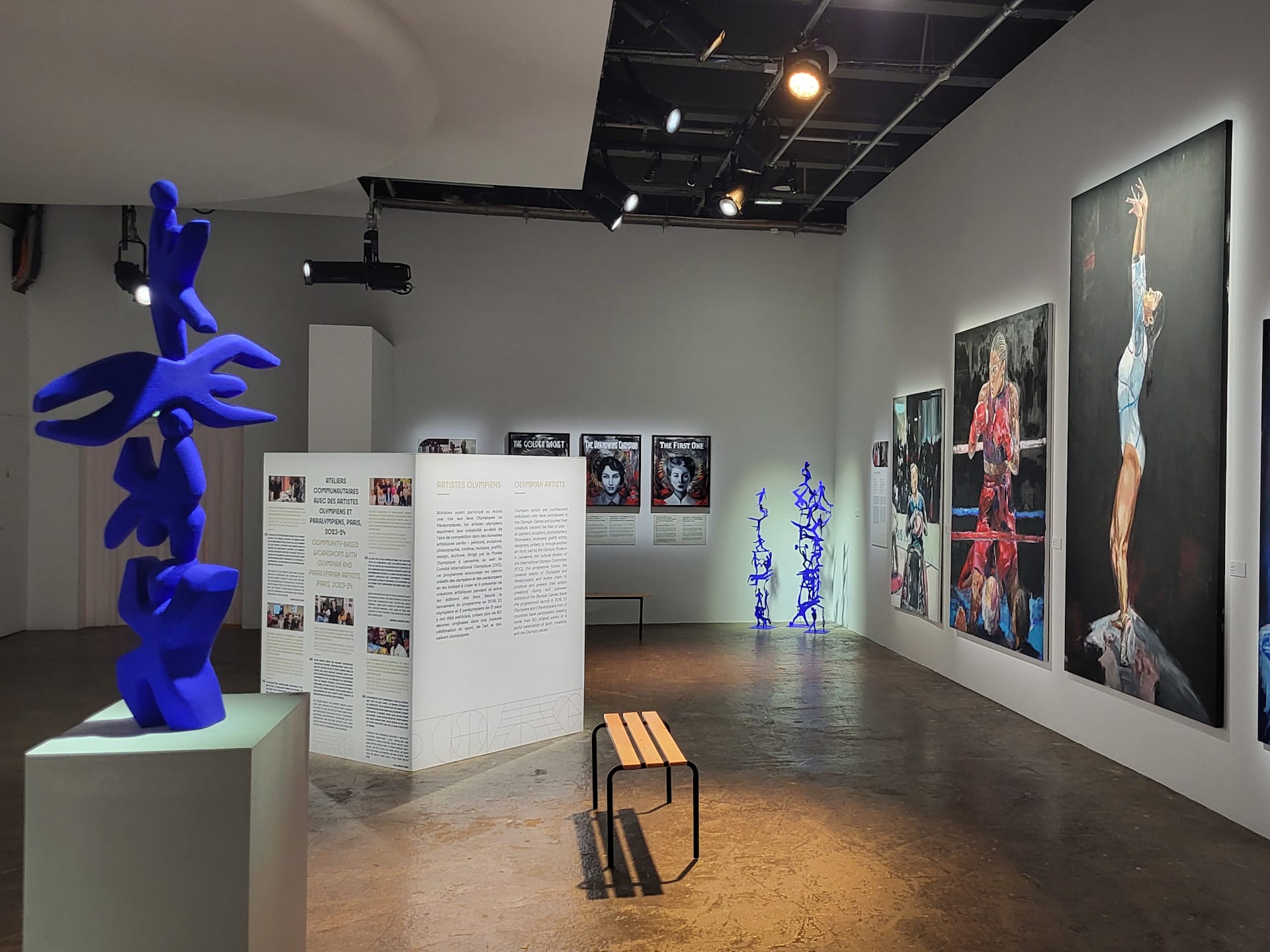 Artworks by Olympians on view at Palais de Tokyo (Clubhouse) during the Olympic Games Paris 2024. At right: Oil paintings by Luc ABALO. At left, sculpture by Clementine STONEY MACONACHIE. In the back, oil paintings by Brooklyn MCDOUGALL.