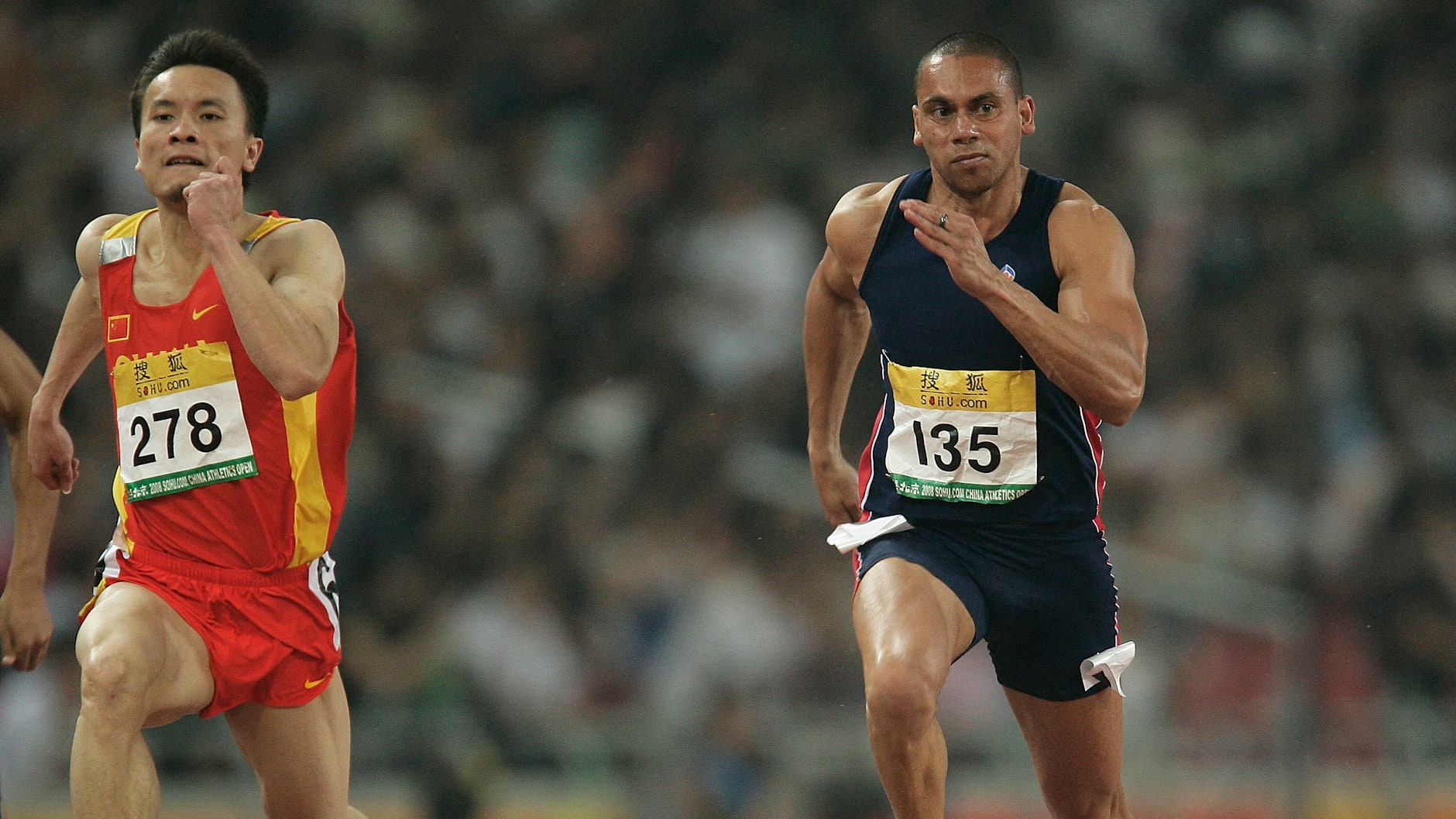 Wen Yongyi of China beats Patrick Johnson in the men's 100m second round during the Good Luck Beijing 2008 China Athletics Open.