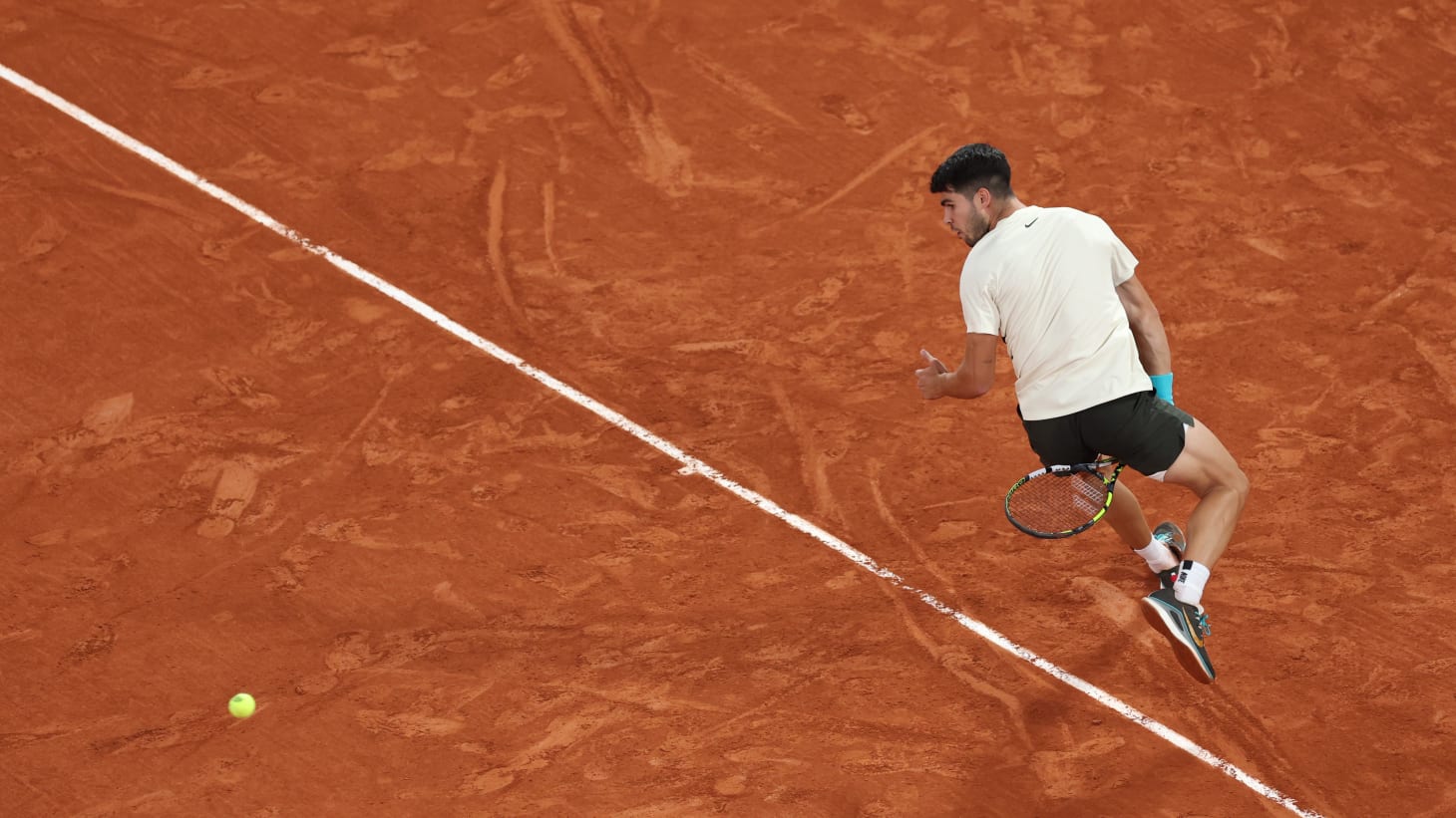 Carlos Alcaraz of Spain plays a shot between the legs against Lorenzo Musetti of Italy during the Men's Singles Semi Final match on Day Thirteen of the 2025 French Open at Roland Garros