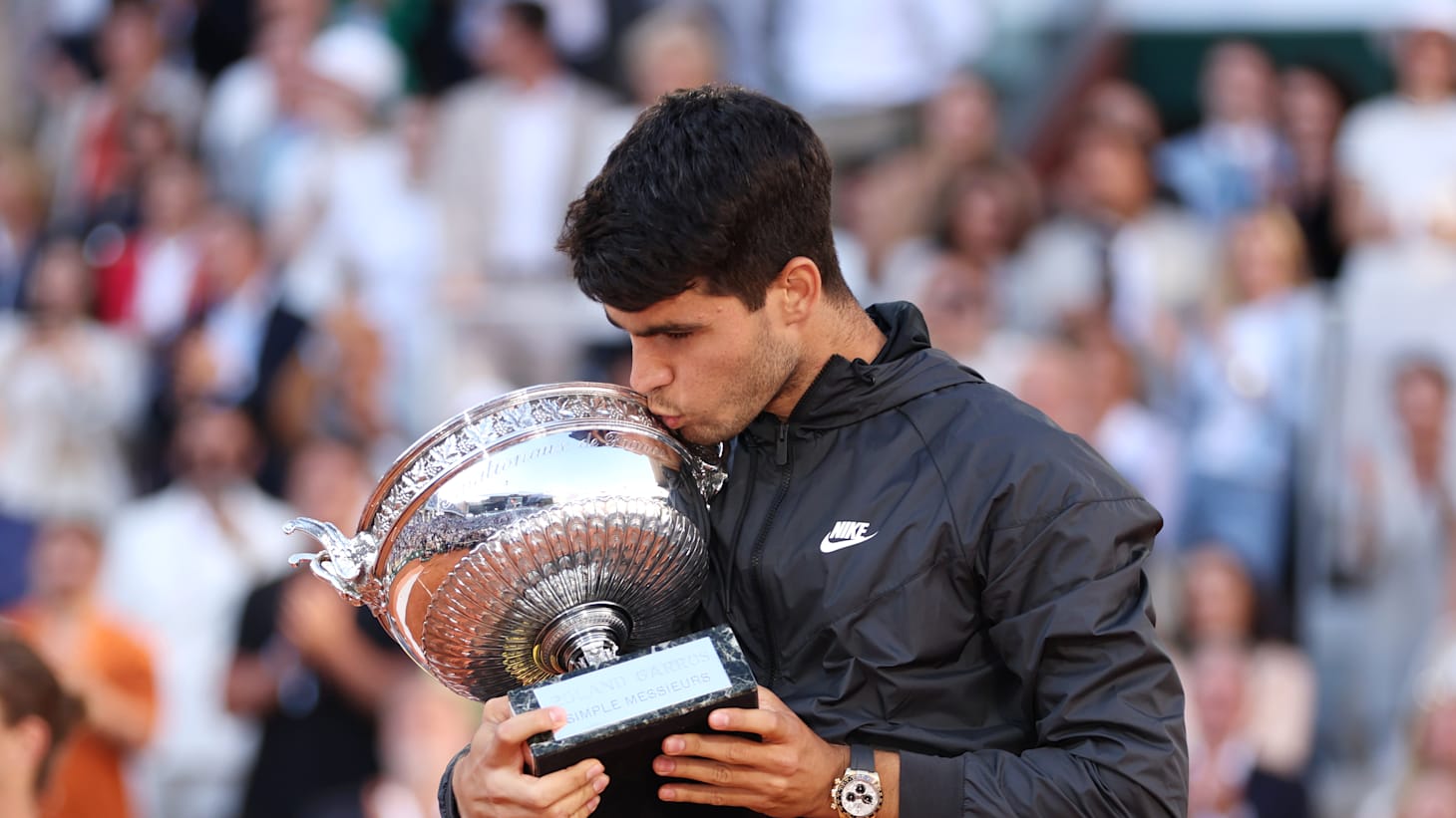Carlos Alcaraz of Spain kisses the winners trophy after victory in the Men's Singles Final match between Alexander Zverev of Germany and Carlos Alcaraz of Spain on Day 15 of the 2024 French Open at Roland Garros on June 09, 2024 in Paris, France.