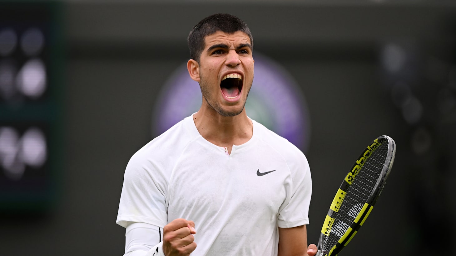 Carlos Alcaraz of Spain celebrates match point against Jan-Lennard Struff of Germany during the Men's Singles First Round match during Day One of The Championships Wimbledon 2022