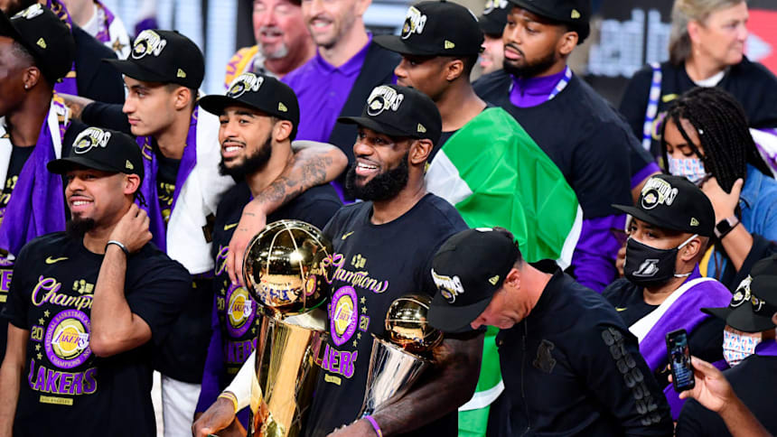  LeBron James of the Los Angeles Lakers reacts with his MVP trophy and Finals trophy after winning the 2020 NBA Championship over the Miami Heat 