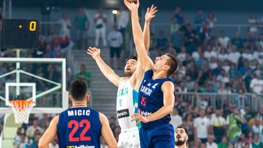 Nikola Jokic competes for the ball against Mike Tobey of Slovenia in an August friendly