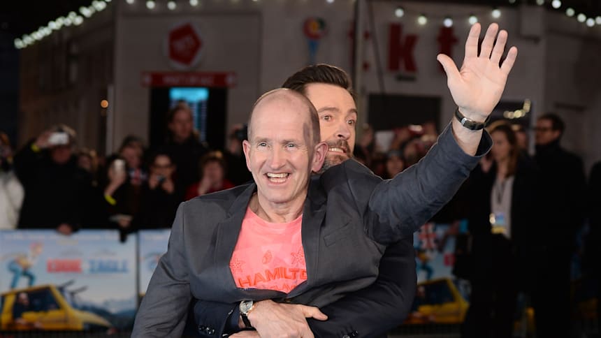 Michael 'Eddie the Eagle' Edwards receiving a hug from actor Hugh Jackman at the European premiere of the film about his life  