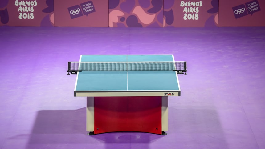 A table tennis table is made of fibrewood that is split into two halves.