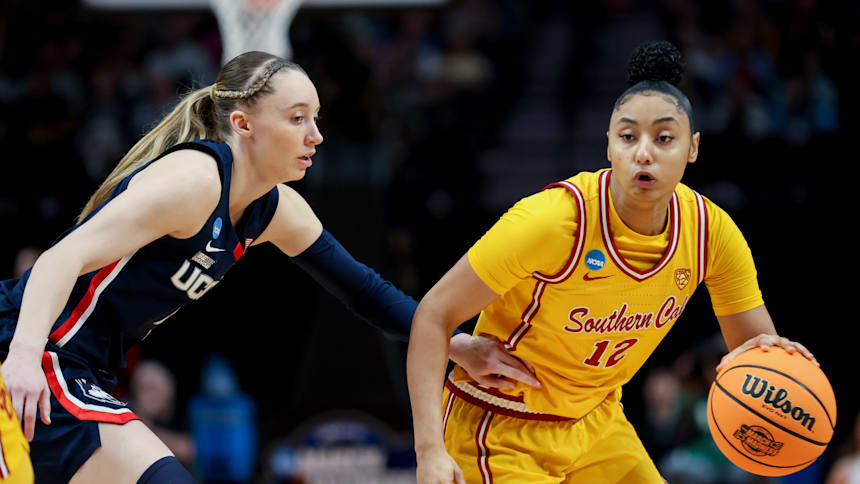 JuJu Watkins #12 of the USC Trojans drives past Paige Bueckers #5 of the Connecticut Huskies.