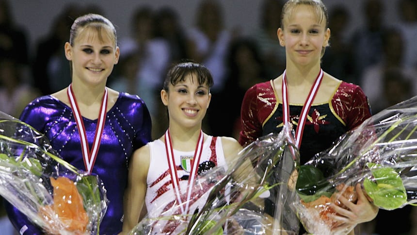 Vanessa Ferrari (C) celebrating her all-around gold medal at the 2006 World Artistic Gymnastics Championships in Arhus, Denmark.