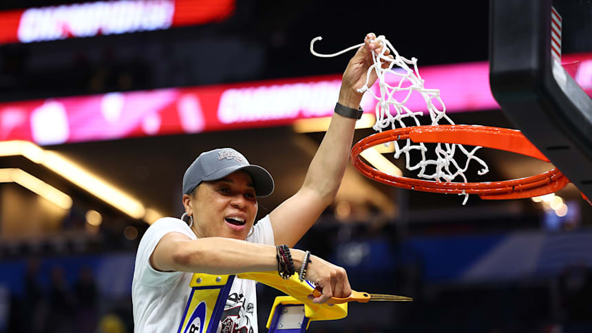 Dawn Staley cuts down the net at Target Center in Minneapolis after the 2022 National Championship game