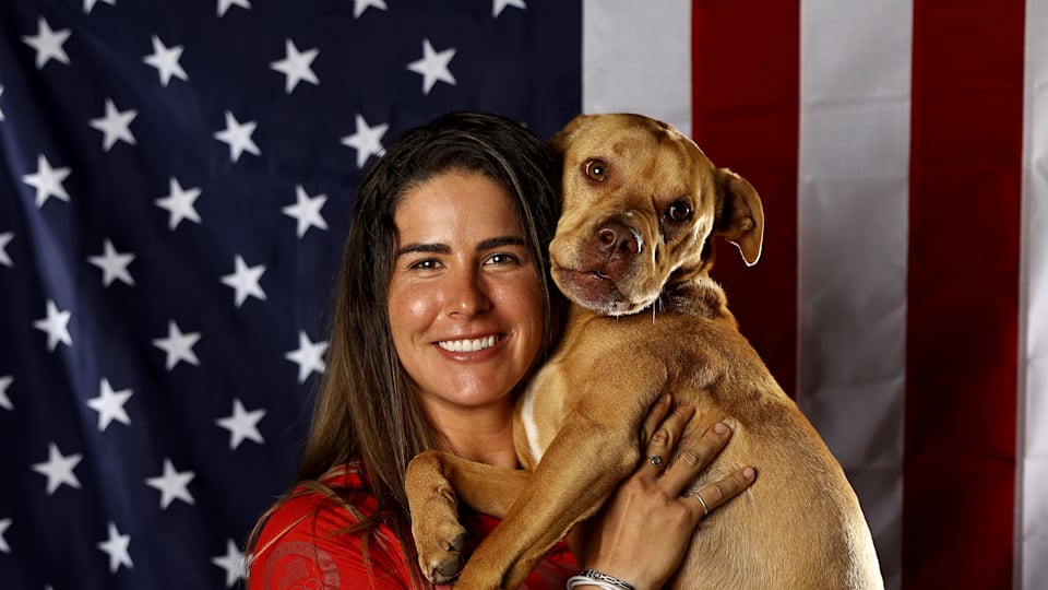 Cyclist Mandy Marquardt poses with her dog Ruby