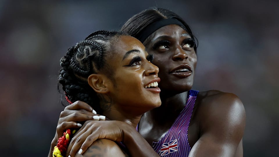Daryll Neita and Sha'Carri Richardson embrace after the 2023 World Championships women's 200m final