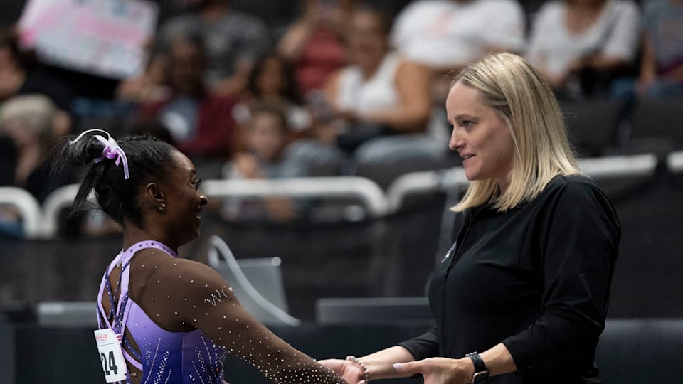 Simone Biles (left) is congratulated by coach Cecile Canqueteau-Landi (right)