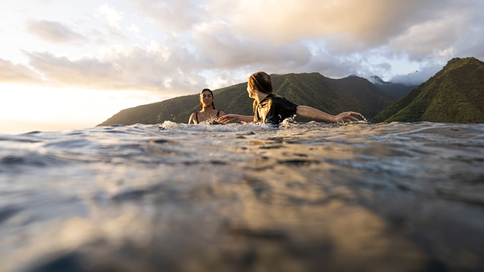 Sol Aguirre and Tiara van der Huls surf during the 2023 ISA Athlete Training Camp in Tahiti. 