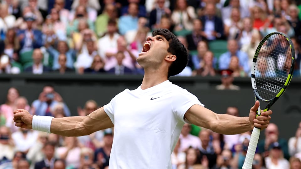 Carlos Alcaraz of Spain celebrates winning match point against Daniil Medvedev in the Men's Singles Semi-Final match during day twelve of The Championships Wimbledon 2024 at All England Lawn Tennis and Croquet Club on July 12, 2024 in London, England.