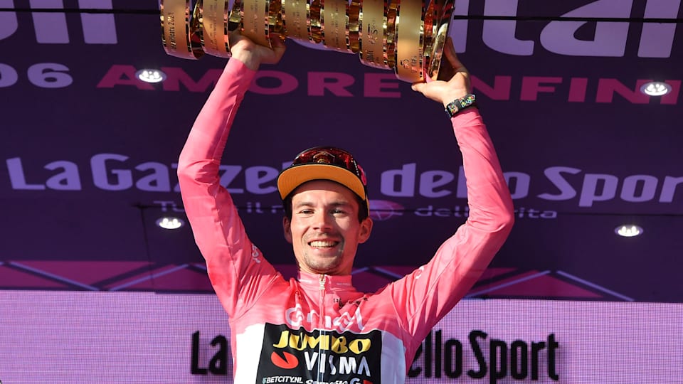 Primoz Roglic celebrates on the podium with the trophy after winning the 2023 Giro d'Italia
