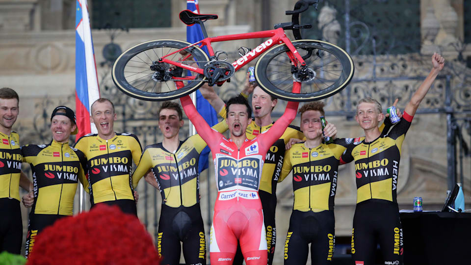 Cycling - Vuelta a España - Stage 21 - Padrón to Santiago de Compostela - Spain - September 5, 2021 Jumbo-Visma's Primoz Roglic celebrates on the podium after winning the general classification with teammates.