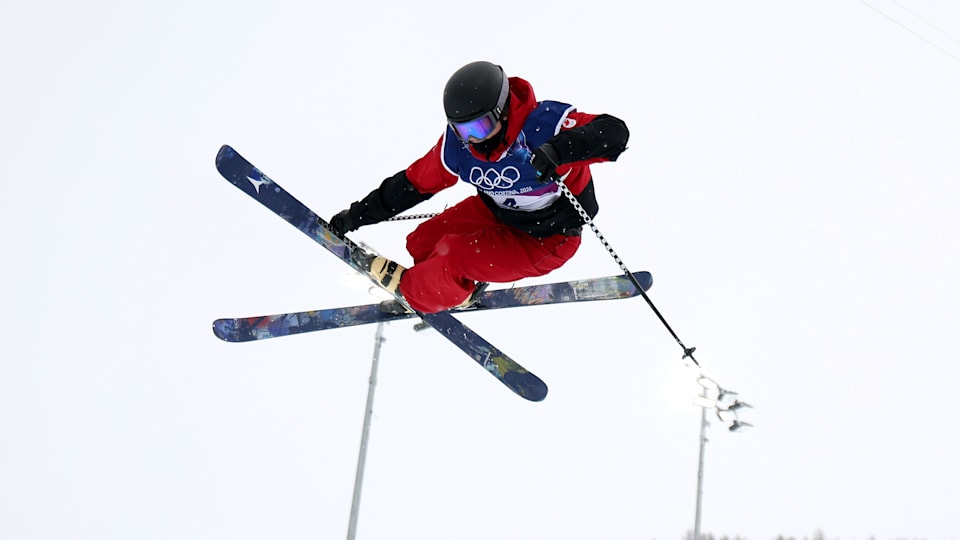 Freestyle skier performing a big air trick during competition