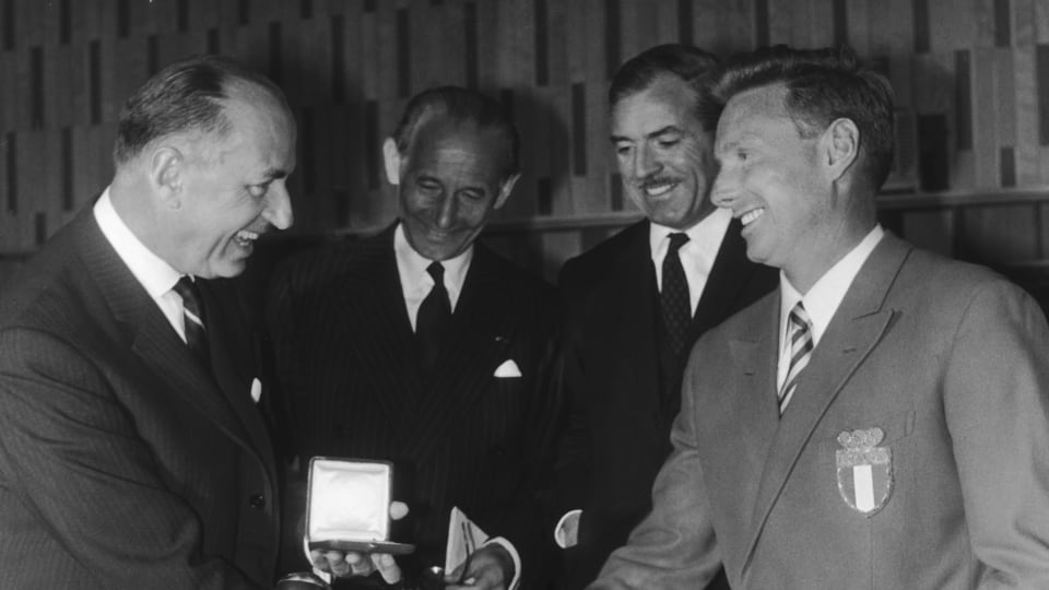 UNESCO Director-General Rene Maheu awards the International Fair Play trophy to Italian bobsleigh champion Eugenio Monti in 1965. Monti won the award for an act of sportsmanship during the 1964 Winter Olympics in Innsbruck.