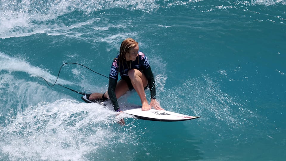 A female surfer rides an artificial wave.
