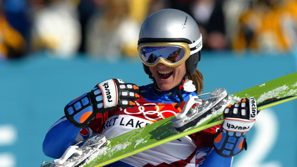 Isabelle Blanc of France plays her snowboard as a guitar after winning the final of the women's parallel giant slalom at Salt Lake City 2002