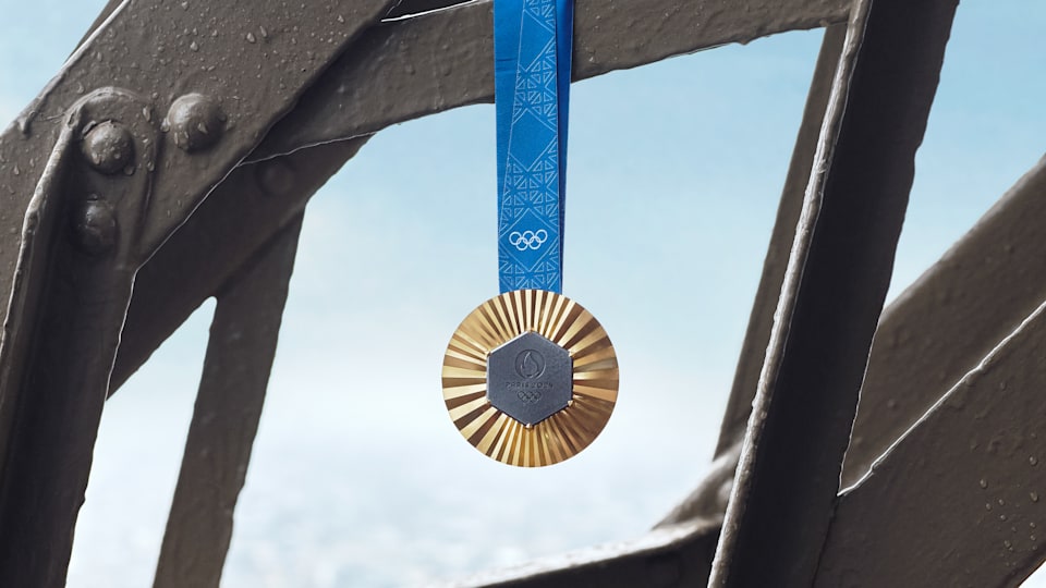 Olympic Games Paris 2024 gold medal hanging from the Eiffel Tower
