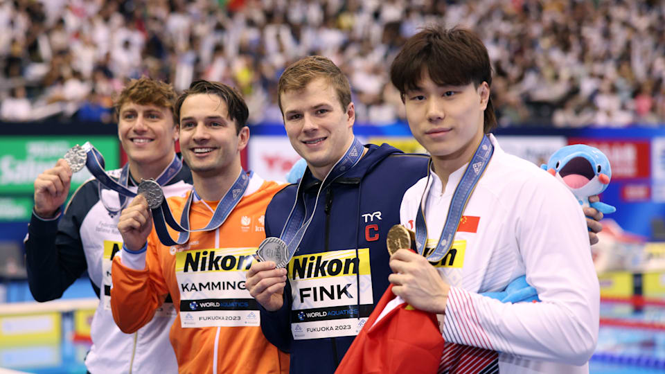Gold medallist Qin Haiyang and silver medallists Nicolo Martinenghi, Arno Kamminga and Nic Fink pose with their medals after the men's 100m breaststroke final