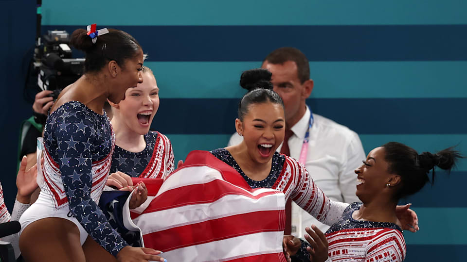 Jordan Chiles, Jade Carey, Sunisa Lee and Simone Biles of Team United States celebrate winning the gold medal during the Artistic Gymnastics Women's Team Final