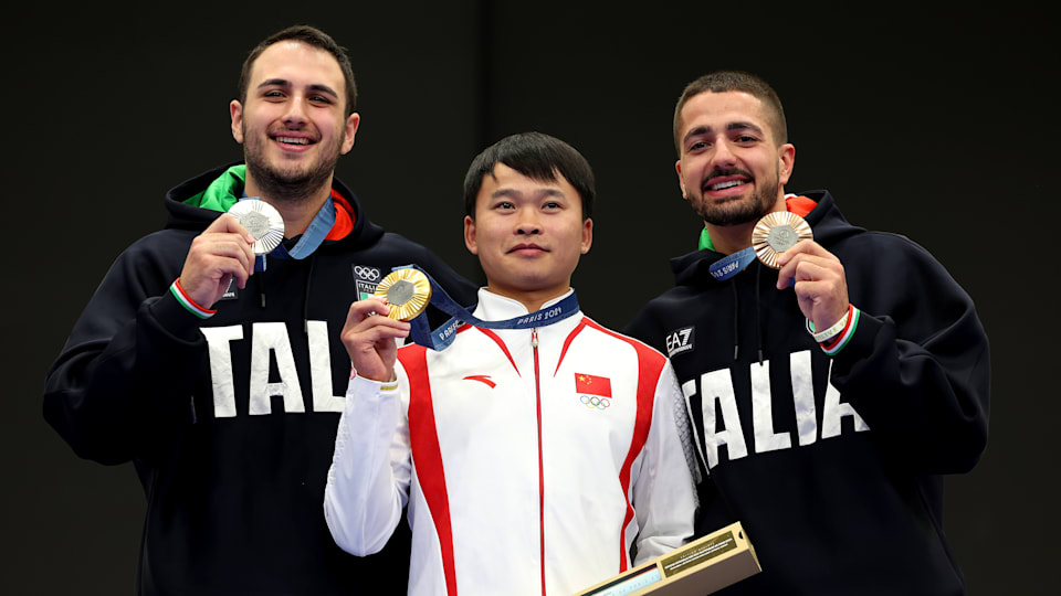 The men's 10m air rifle podium: Yu Xie (C), Federico Nilo (L) Paolo Monna (R) 
